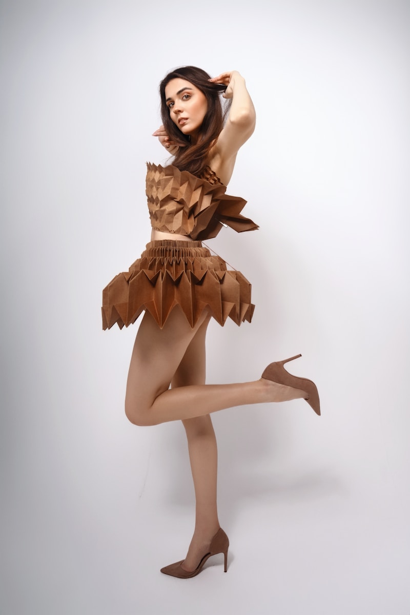 A woman in a brown dress is posing for a picture