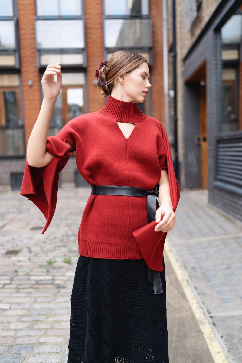 A woman in a red sweater and black skirt