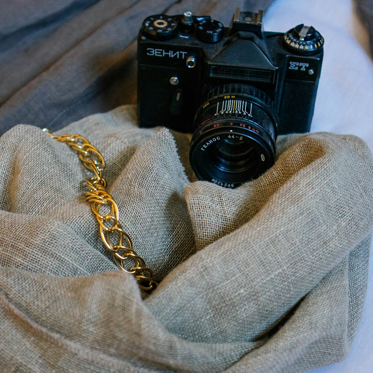 black nikon dslr camera on gray textile