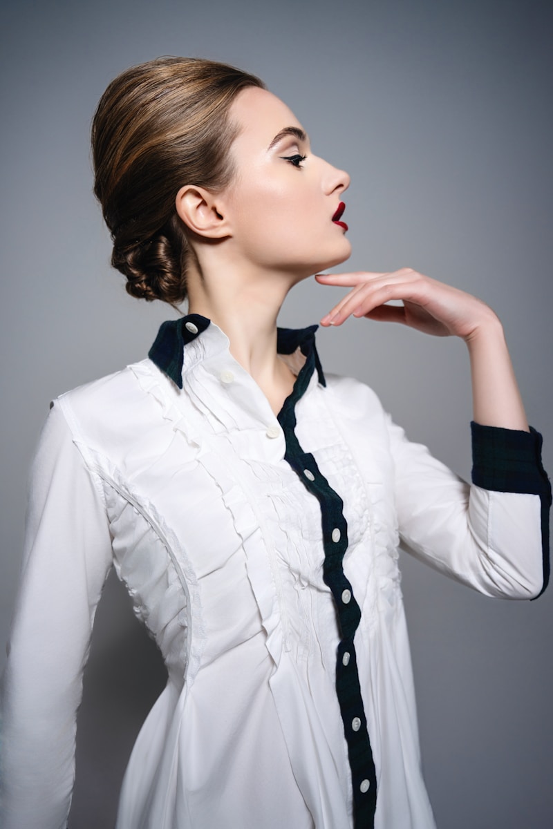 A woman in a white shirt and black tie