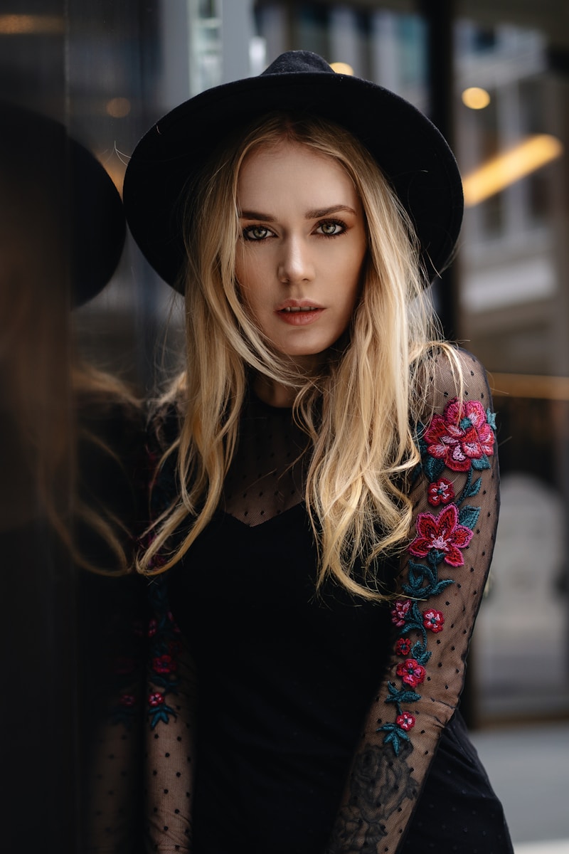 A woman in a black dress and a black hat